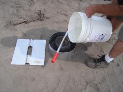 Now, for the first time, a field instrument to measure the rate of water infiltration on all areas. This instrument determines the downward flow of water through the soil.  Rings come complete with two ports to attach optional Mariotte Tubes (IN12-W).  Photo showing optional driving plate IN6-W